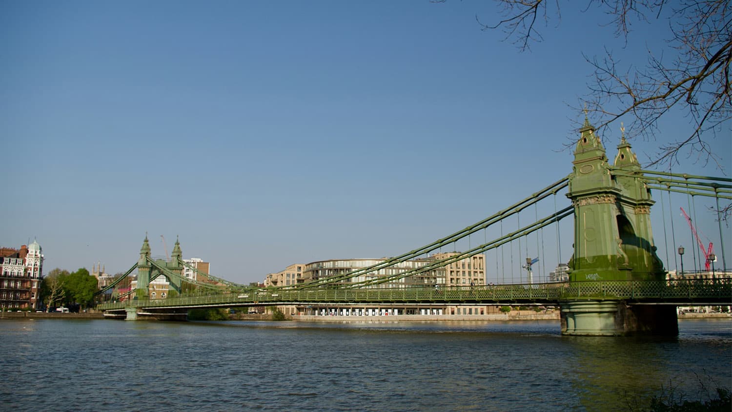 People walking together beside the River Thames